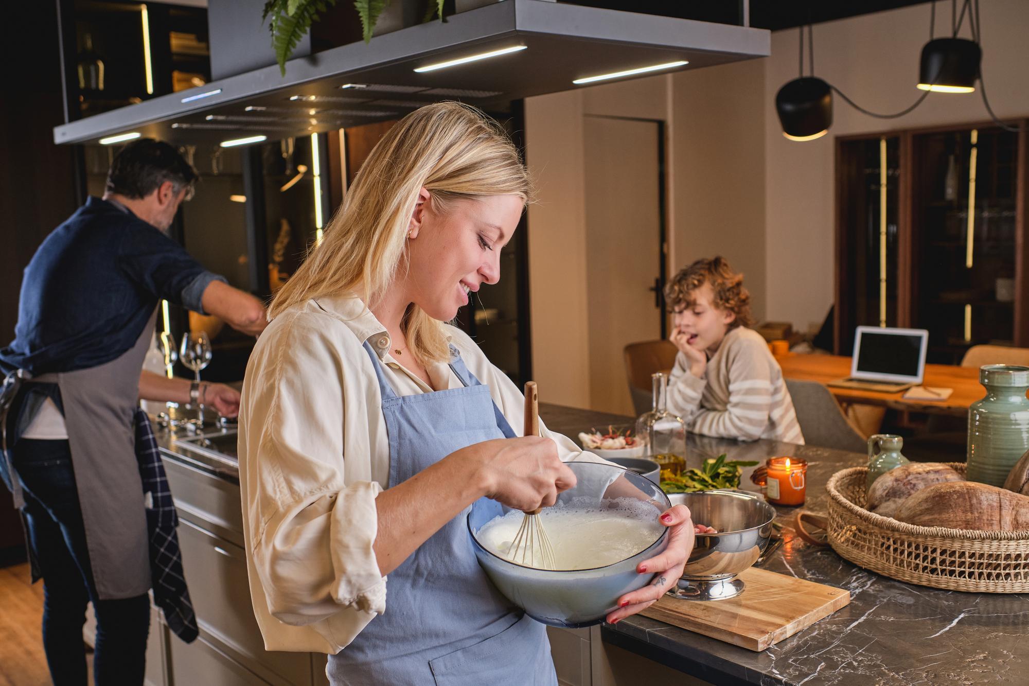 Small team preparing mise en place in warm kitchen
